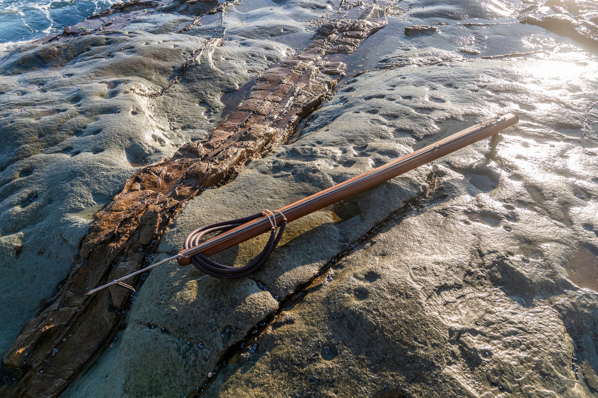 Complete Photo of Bombora 130RH Speargun sitting on rocks at Avoca in early morning sun